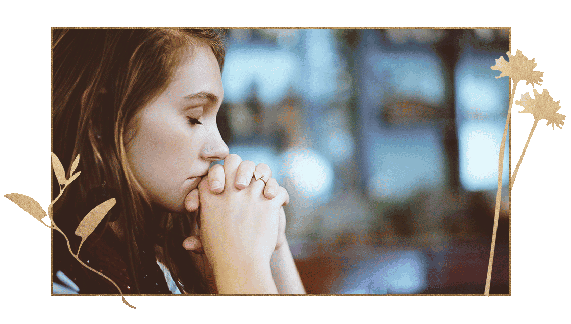 Woman with hands clasped meditating