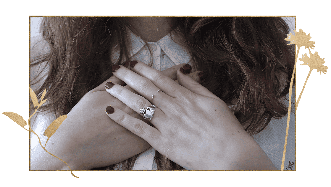 close up of womans hands crossed over heart